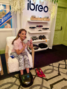 Woman holding Ibreo product and receiving a foot massage