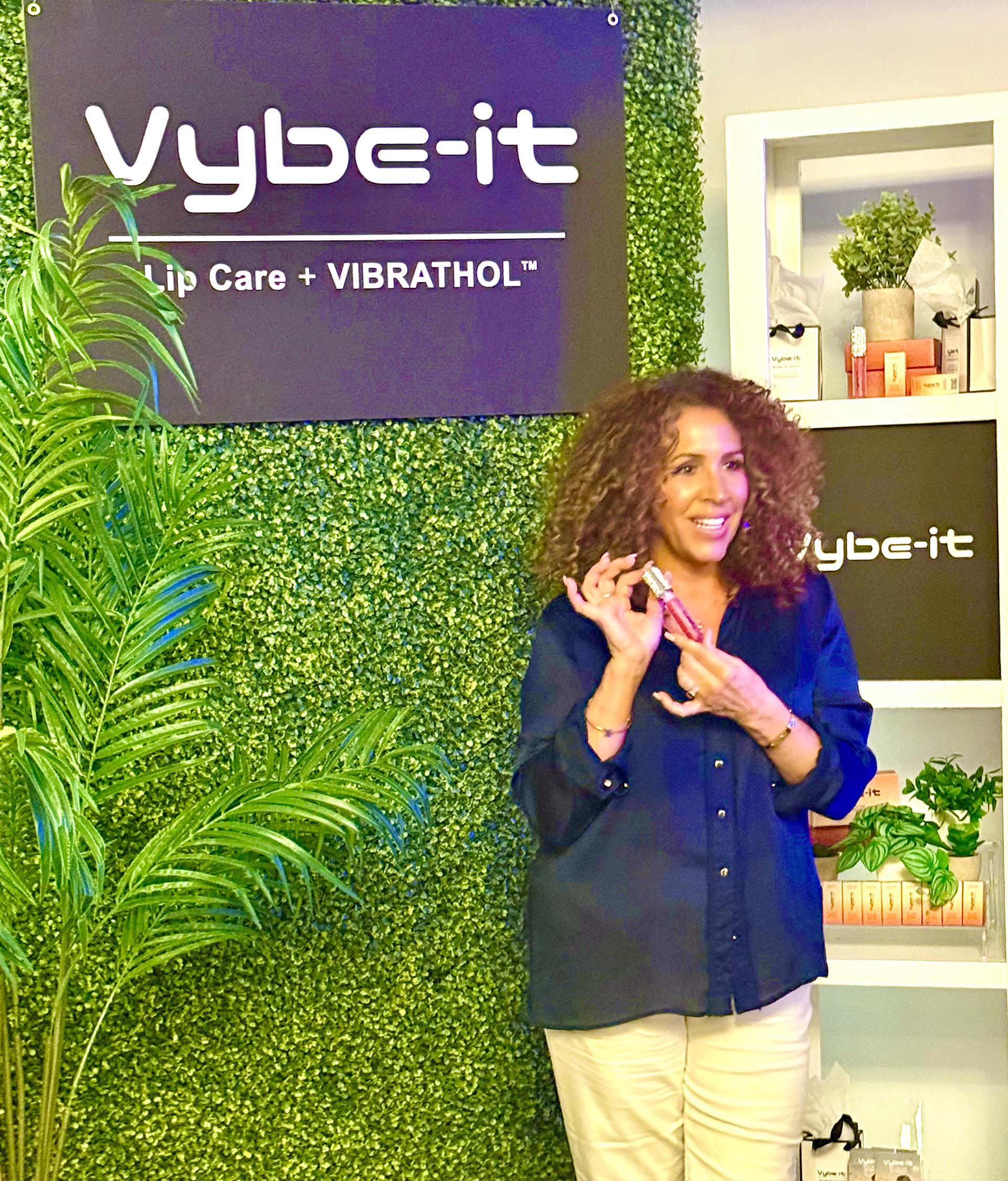 Woman holding Vybe-It Lip Plumper