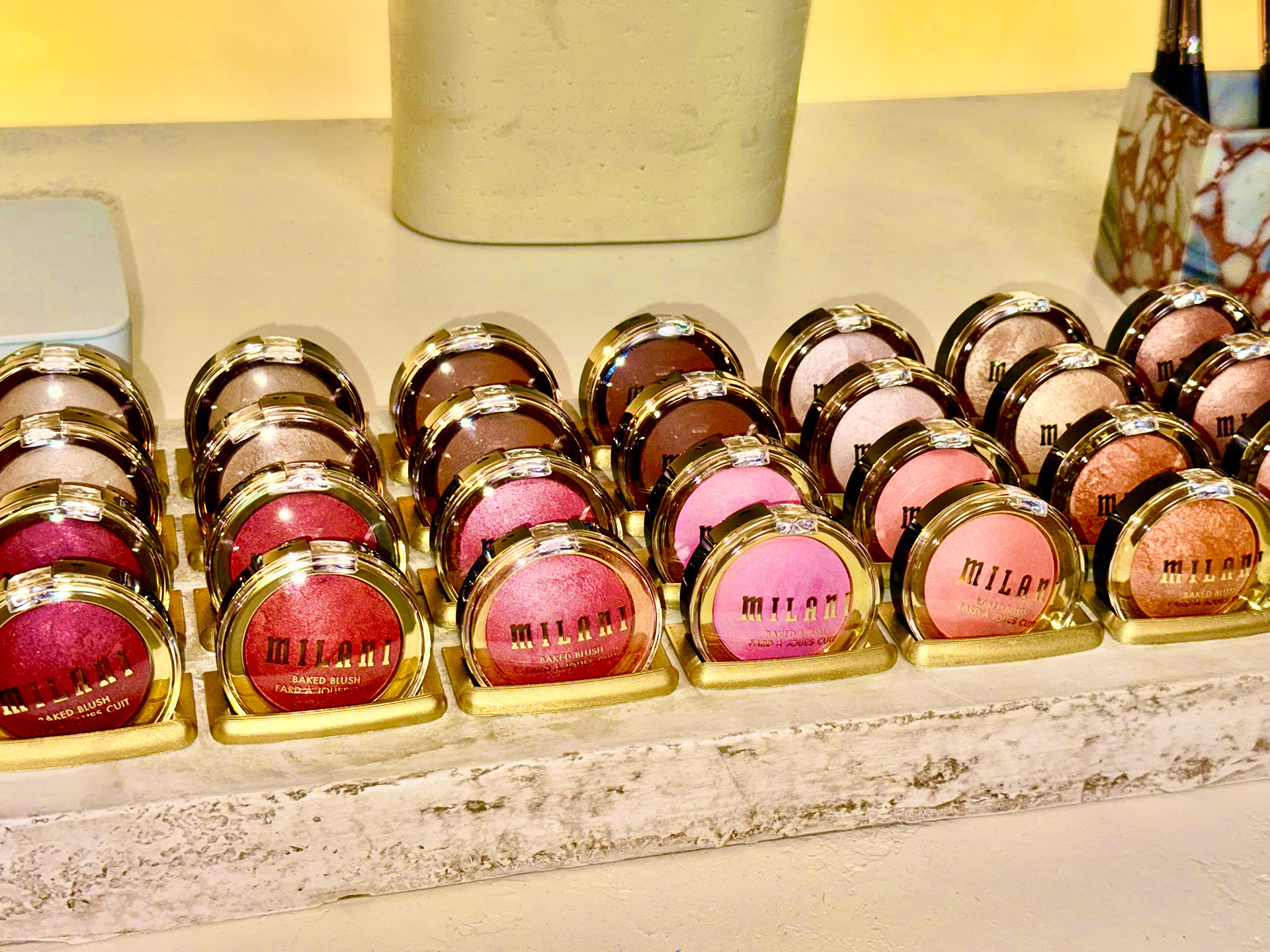 Milani Baked Blushes display Milani Baked Blushes in a display case