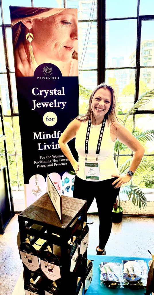 Cat in front of Wonderlight Crystal Jewelry for Mindful Living booth at Live Love Spa LA 2025