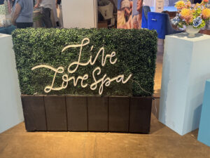 Live Live Spa neon sign on greenery