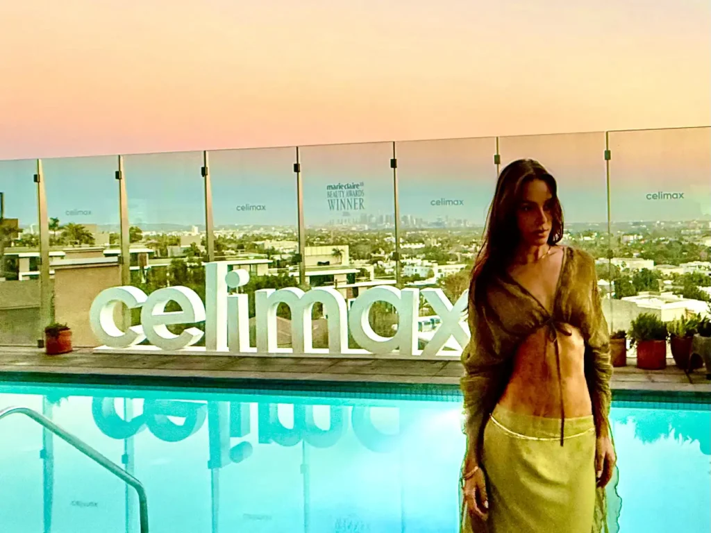 Women in front of pool with giant Celimax sign at the 1 Hotel West Hollywood